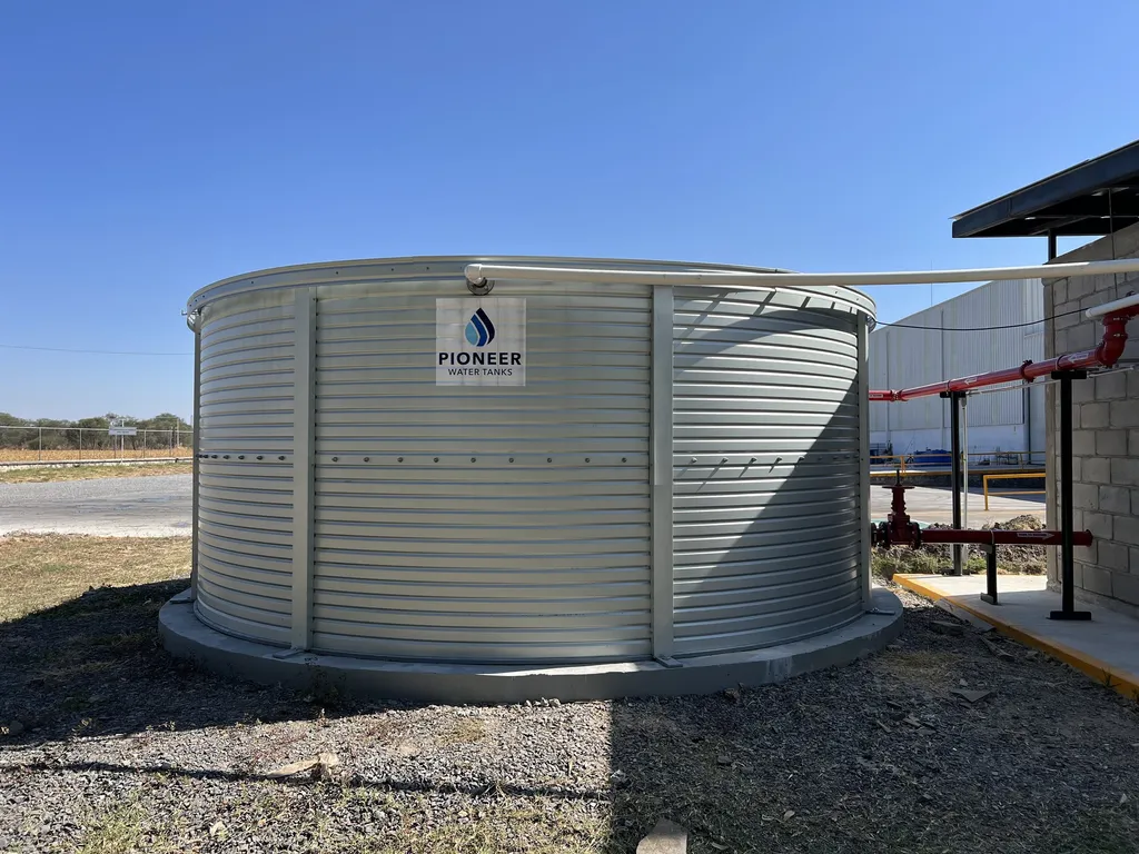 Bolted steel fire water tank, completed on site next to the industrial building.